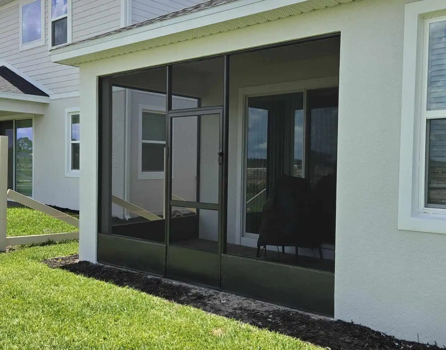 Lanai screen replacement project showing clear sky and new structure.