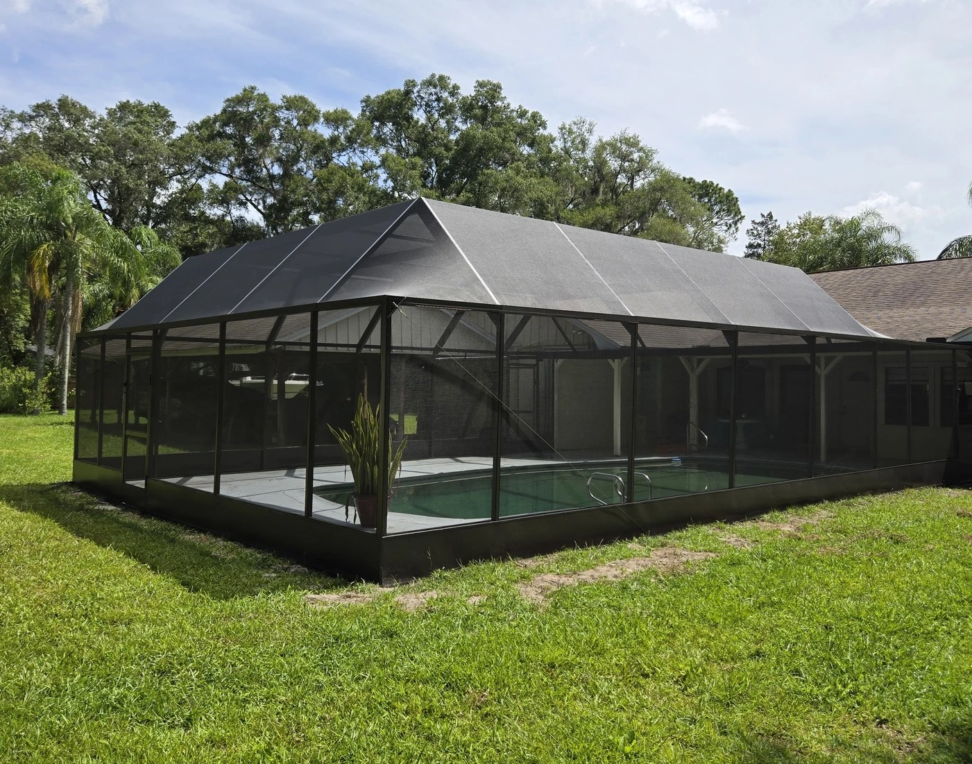 Rescreening a pool enclosure damaged by storm in St. Cloud, FL."